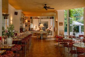 a restaurant with tables and chairs and a kitchen at Coco Hotel in Copenhagen