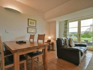 a living room with a wooden table and a couch at Northrawe in Bamburgh