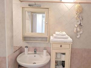 a bathroom with a sink and a mirror at Libeccio House in Avola
