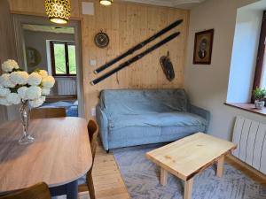 a living room with a couch and a table at Echappée Verte in Breitenbach-Haut-Rhin