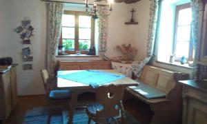 a dining room with a table and a cross on the wall at Ferienhaus Goldegg 1 in Artstetten