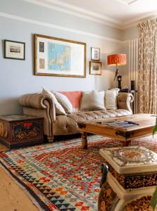 a living room with a couch and a coffee table at Ty'n Porth - By Rowes Retreats in Falmouth +29 photos