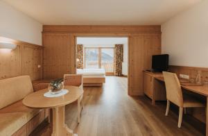 a living room with a couch and a table at Hotel Plunger in Castelrotto