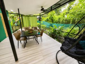 a screened in porch with a table and chairs at Jungle Serenity Haven in Cocles