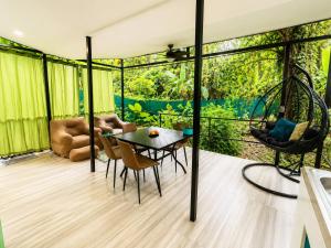 a room with a patio with a table and chairs at Jungle Serenity Haven in Cocles +3 photos