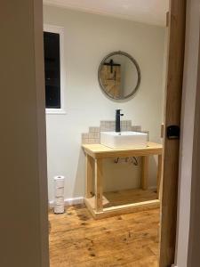 a bathroom with a sink and a mirror on the wall at FireFly Starry Woods Cabin in Keurboomstrand +51 photos