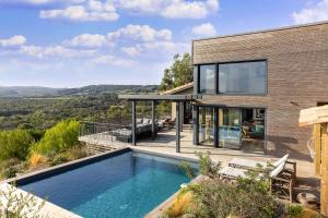 a house with a swimming pool on a hill at Résidence Casarina in Bonifacio