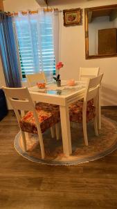 a white table with two chairs and a table with at Villa Rafin dvor in Vrsi