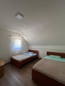 a room with two beds and a window in it at Everpine house in Žabljak +7 photos
