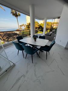 a table and chairs in a room with a view of the ocean at Mi Capricho in Mijas Costa