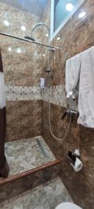 a bathroom with a shower with a glass door at Hotel Erebuni Plaza in Yerevan