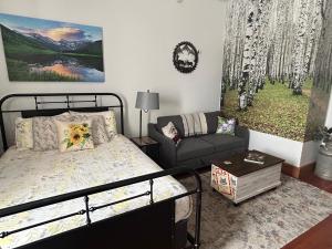 a bedroom with a bed and a couch at Aspen Inn in Creede