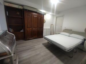 a small room with a bed and a cabinet at Villa Maddalena Brianza in Lentate sul Seveso