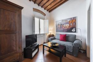 a living room with a couch and a table at Borgo Allegri Palace By MMega in Florence