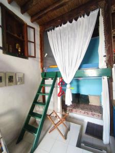 a bunk bed in a room with a ladder and a window at Kastro Astypalea Spitaki in Astypalaia