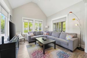 a living room with a couch and a table at The Jackrabbit - 3 Summer Village in Cherry Valley