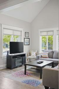 a living room with a couch and a tv at The Jackrabbit - 3 Summer Village in Cherry Valley