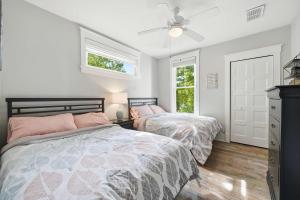 a bedroom with two beds and a ceiling fan at The Jackrabbit - 3 Summer Village in Cherry Valley