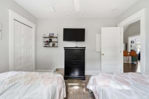 a bedroom with a bed and a flat screen tv on a wall at The Jackrabbit - 3 Summer Village in Cherry Valley +89 photos