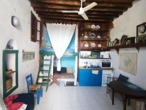 a kitchen with a room with a ladder and a table at Kastro Astypalea Spitaki in Astypalaia