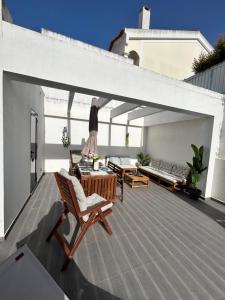 a woman standing on the roof of a house at Valadares Pool Villa in Corroios +50 photos