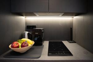 a bowl of fruit on a counter in a kitchen at Nest In The Yard in Parga +20 photos