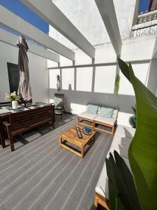 a living room with a couch and a table at Valadares Pool Villa in Corroios