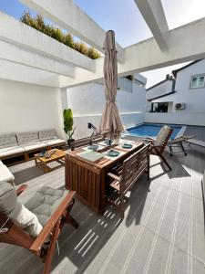 a living room with a table and chairs and a pool at Valadares Pool Villa in Corroios