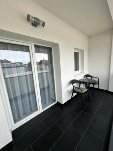 a room with two chairs and a table on a balcony at Apartament Bucovina Bellevue in Gura Humorului +2 photos