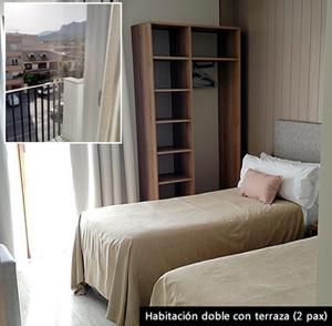 a bedroom with two beds and a book shelf at Hotel Vélez in Vélez-Rubio