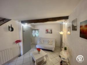 a living room with a couch and a table at La paraguère in Sorède +21 photos