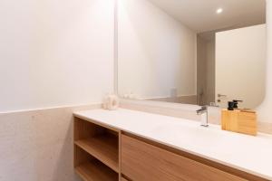 a bathroom with a sink and a mirror at ASTRO Emanuelle E by LovelyStay in Leça da Palmeira +23 photos
