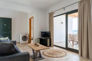 a living room with a couch and a sliding glass door at Helen's 11 boutique in Achladies