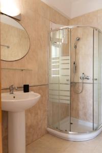 a bathroom with a glass shower and a sink at Helen's 11 boutique in Achladies +72 photos