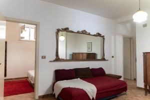 a bedroom with a bed and a mirror on the wall at Pugliaholidayplus - IL VILLONE NEL BOSCO in Polignano a Mare