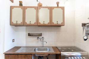 a kitchen with a sink and a stove at Pugliaholidayplus - IL VILLONE NEL BOSCO in Polignano a Mare +62 photos