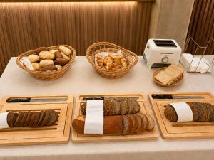 a table with several different types of bread and pastries at Hotel Drei Könige in Chur
