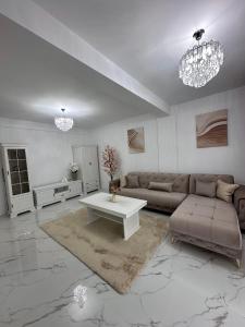 a living room with a couch and a table at Apartament Bucovina Bellevue in Gura Humorului
