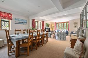 a dining room with a long table and chairs at Hockley House by Bloom Stays in Folkestone