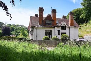 an old house in the middle of a field at Hockley House by Bloom Stays in Folkestone