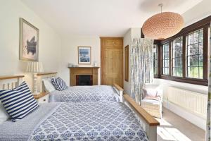 a bedroom with a bed with blue and white sheets at Hockley House by Bloom Stays in Folkestone