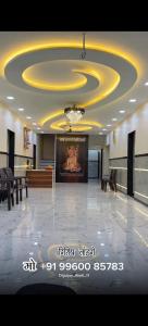 a lobby with a large ceiling with a chandelier at Sai Samarth Residency Akkalkot in Akalkot