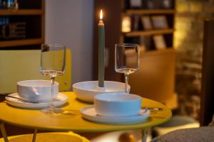 a table with a candle and two glasses on it at zons22 Tiny Loft in Historic Zons - between Cologne & Düsseldorf in Dormagen