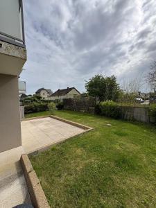 a yard with a patio and a backyard with a house at Studio with garden in Dinard