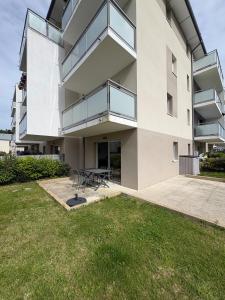a large white building with a picnic table in a yard at Studio with garden in Dinard