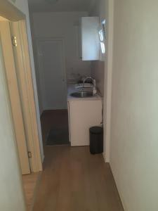 a small kitchen with a sink and a counter at Apartman Almira in Donji Štoj