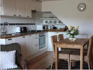 a kitchen with a wooden table with chairs and a table sidx sidx sidx at Willow Cottage in Presteigne