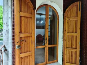 a pair of wooden doors on a house at Villa Carol in Polinago