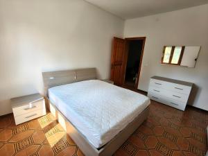 a bedroom with a bed and a dresser and a mirror at Villa Carol in Polinago