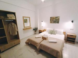 a large bedroom with a bed and a dresser at Elena Apartments in Keramoti